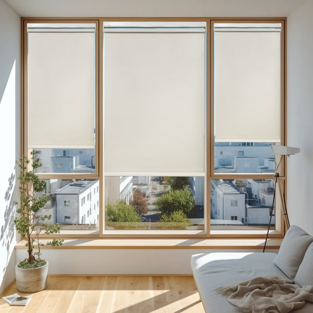 Cordless blackout roller blinds partially open with sunlight entering living room