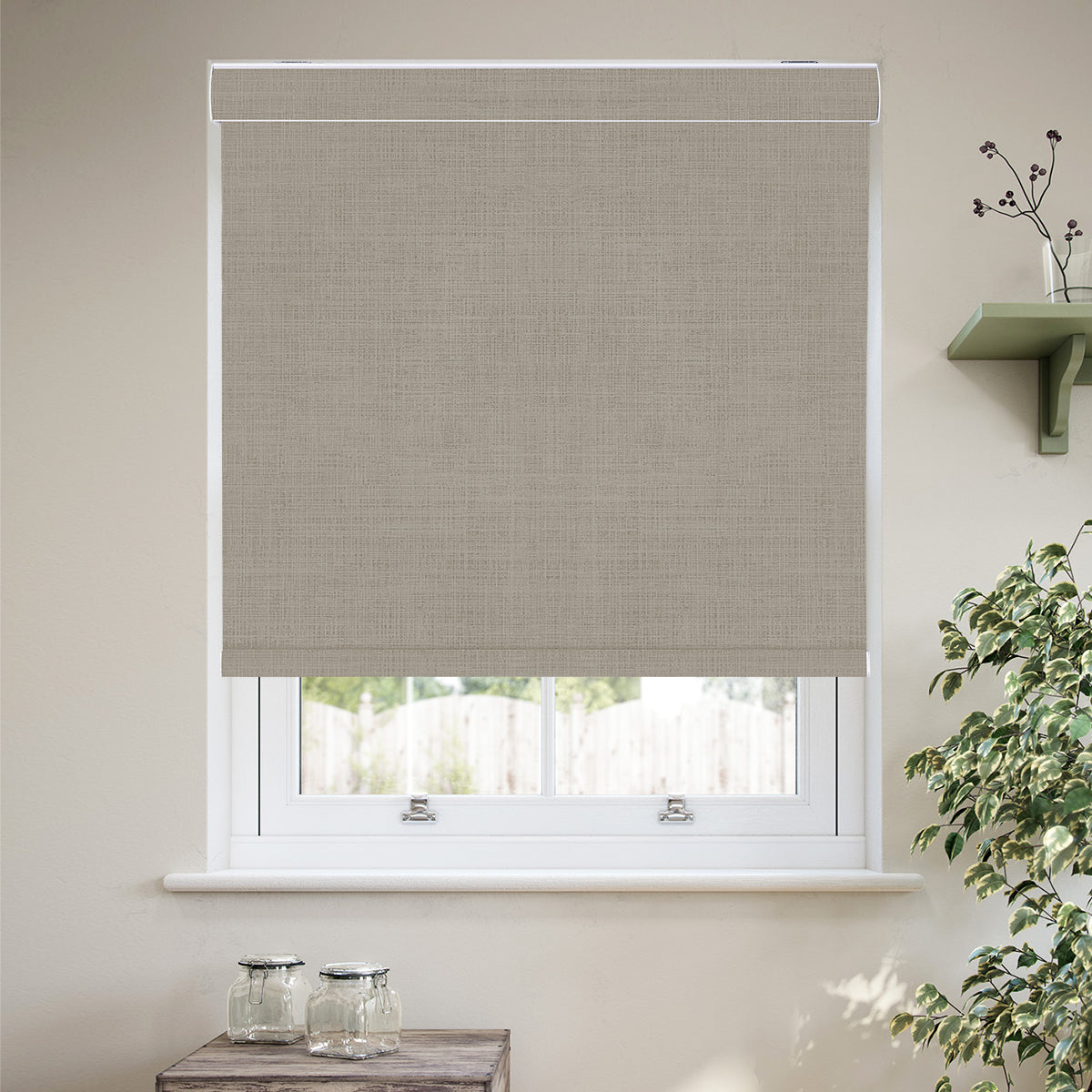 Custom cordless cassette blackout roller shades in a modern living room, featuring 100% blackout fabric, a sleek aluminum cassette, custom fit, and child-safe cordless operation.