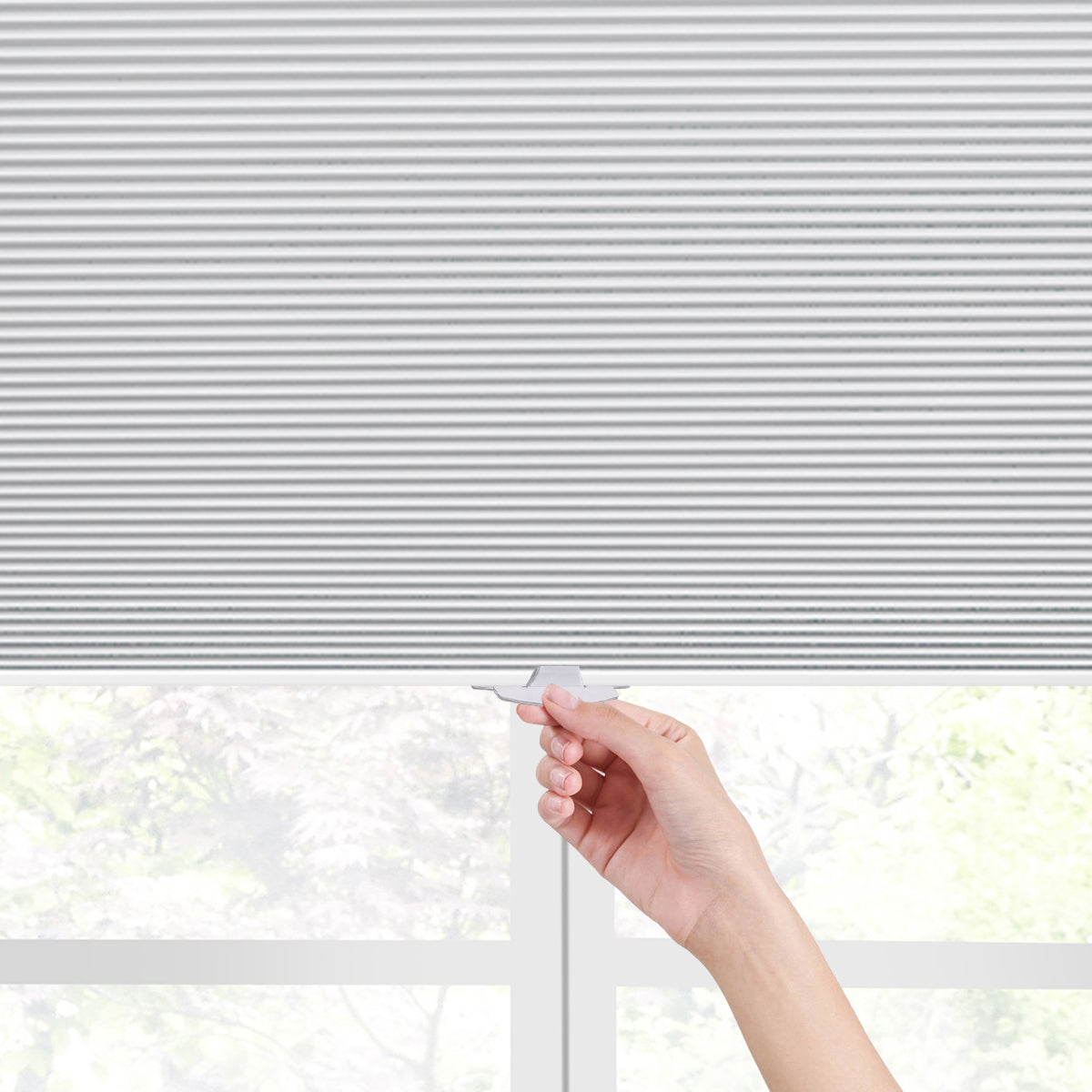 Hand pulling ergonomic handle of cordless no drill cellular honeycomb shades for height adjustment