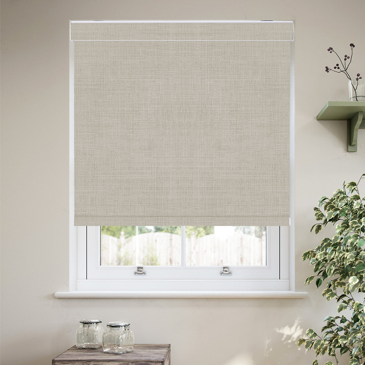Custom cordless cassette blackout roller shades in a modern living room, featuring 100% blackout fabric, a sleek aluminum cassette, custom fit, and child-safe cordless operation.