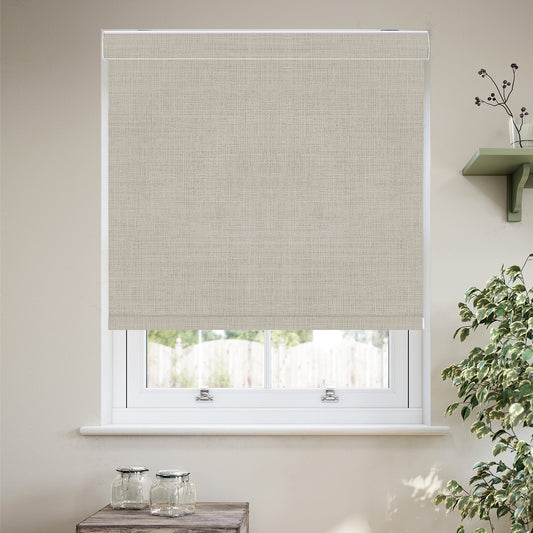Custom cordless cassette blackout roller shades in a modern living room, featuring 100% blackout fabric, a sleek aluminum cassette, custom fit, and child-safe cordless operation.