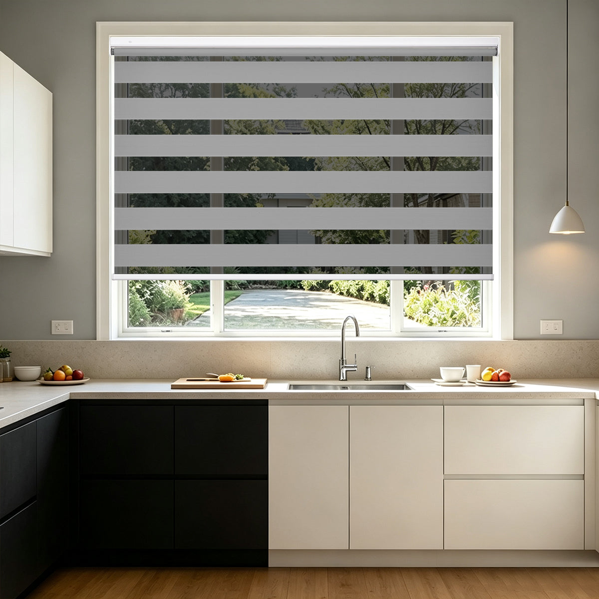 No Drill Cordless Blackout Zebra Shades – Light Grey dual layer zebra blinds, installed on kitchen sink window, modern two-tone cabinet interior